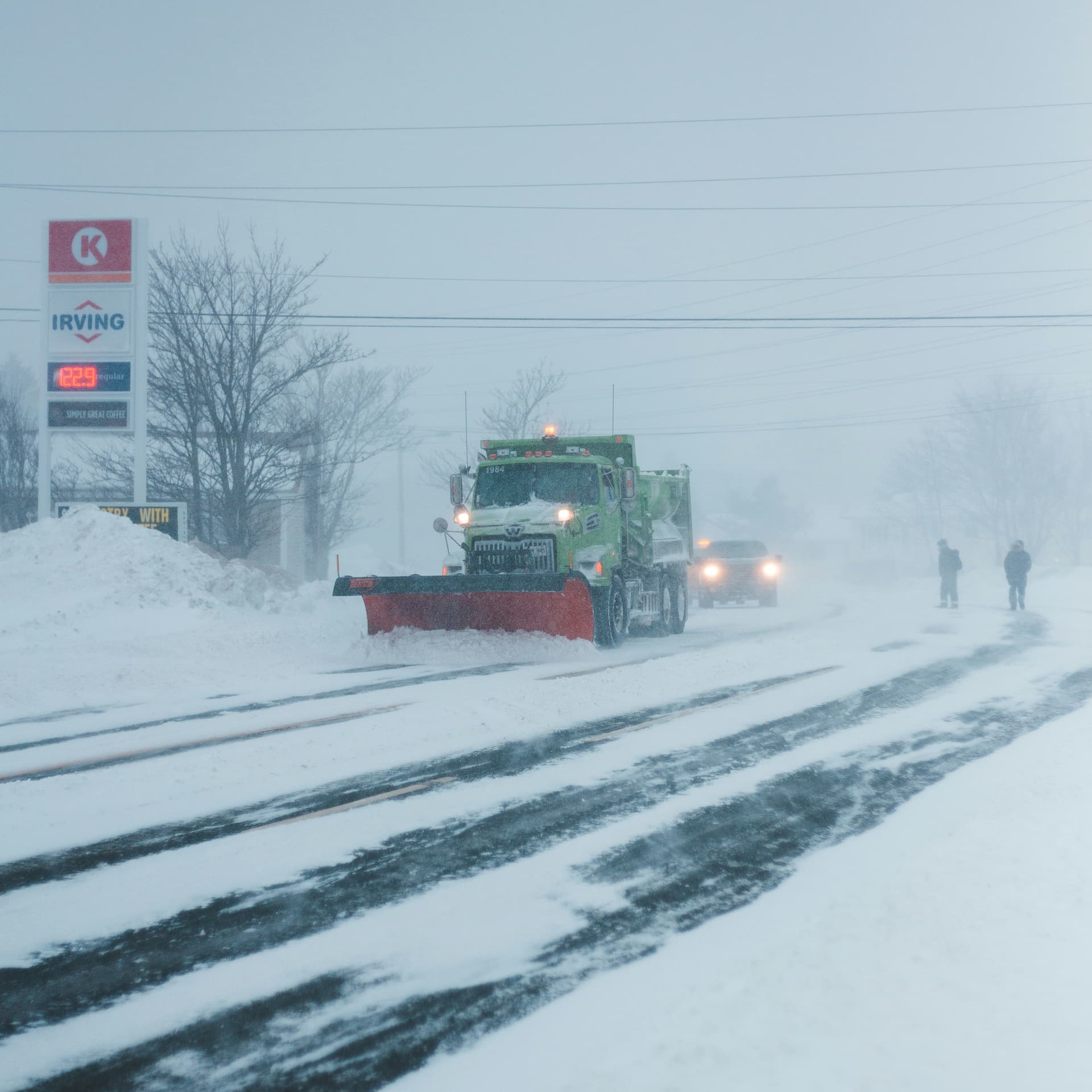 Snow removal crew clearing a commercial parking lot